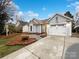 Gray exterior with a two-car garage and well-manicured lawn at 10306 Creswell Ct, Charlotte, NC 28215