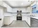 Modern kitchen with white cabinets and stainless steel appliances at 10306 Creswell Ct, Charlotte, NC 28215