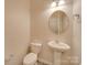 Small bathroom with pedestal sink and rounded mirror at 1033 Cedar Village Trl, Salisbury, NC 28147