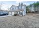 Two-story townhome with gray siding, brick accents, and a two-car garage at 1033 Cedar Village Trl, Salisbury, NC 28147