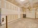 Unfinished garage with overhead door and concrete floor at 1033 Cedar Village Trl, Salisbury, NC 28147