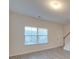 Living room with hardwood floors, neutral walls, and stairs to second floor at 1033 Cedar Village Trl, Salisbury, NC 28147