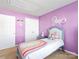 A room with violet-colored walls, a bright bed, and a playful decorative sign at 1107 Stonehenge Ln, Charlotte, NC 28216