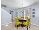 Cozy dining room area with a round table, bright decor, and ample natural light at 1107 Stonehenge Ln, Charlotte, NC 28216