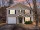 Charming home featuring a classic exterior with a single-car garage and well-maintained landscaping at 1107 Stonehenge Ln, Charlotte, NC 28216