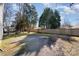 Spacious backyard with gravel, trees, and a wooden fence providing privacy at 114 Juanita Dr, Pineville, NC 28134