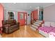 Living room with coral walls, a daybed, and a leather chair at 120 Moyle Ave, Salisbury, NC 28146