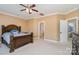 Main bedroom with a large bed, ceiling fan, and ensuite bathroom at 13618 Pacific Echo Dr, Charlotte, NC 28277