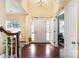 Bright entryway with hardwood floors, a white door, and a staircase at 13618 Pacific Echo Dr, Charlotte, NC 28277