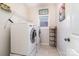 Bright laundry room featuring washer, dryer, and ample shelving at 13618 Pacific Echo Dr, Charlotte, NC 28277