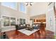 Living room with hardwood floors, a fireplace, and a view of the kitchen at 13618 Pacific Echo Dr, Charlotte, NC 28277