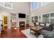 Living room with hardwood floors, fireplace, and view into kitchen at 13618 Pacific Echo Dr, Charlotte, NC 28277