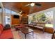 Relaxing screened porch with stone fireplace, ceiling fan, and comfortable seating at 13618 Pacific Echo Dr, Charlotte, NC 28277