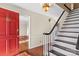 Bright entryway with hardwood floors, staircase, and red door at 140 Kent Rd, Salisbury, NC 28147