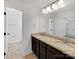 Bathroom with double sinks, granite countertops, and dark cabinets at 1409 Bicycle Ct, York, SC 29745