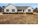 White house with gray shutters, a front porch, and landscaping at 1409 Bicycle Ct, York, SC 29745