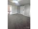 Bright bedroom featuring gray carpeting and barn door at 1443 Modena St, Gastonia, NC 28054