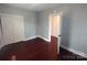 Simple bedroom with hardwood floors and an adjacent room at 1443 Modena St, Gastonia, NC 28054