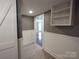 Open hallway with floating shelves and barn door at 1443 Modena St, Gastonia, NC 28054