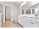 Bright bathroom with double vanity, white cabinetry, and tile flooring with a private water closet at 14812 Baytown Ct, Huntersville, NC 28078