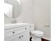 Half bathroom features updated fixtures, modern vanity, and a round mirror at 14812 Baytown Ct, Huntersville, NC 28078