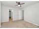 This bedroom features neutral walls, carpet, and a ceiling fan, complemented by ample natural light at 14812 Baytown Ct, Huntersville, NC 28078