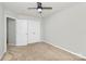 This bedroom is a cozy space featuring a ceiling fan and closet for storage at 14812 Baytown Ct, Huntersville, NC 28078