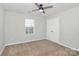 A cozy bedroom featuring carpeted floors, a ceiling fan, and a double-door closet at 14812 Baytown Ct, Huntersville, NC 28078