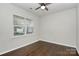 Comfortable bedroom with hardwood floors, a ceiling fan, and a window with natural light at 14812 Baytown Ct, Huntersville, NC 28078