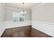 Spacious dining room with wainscoting and a stylish chandelier, ideal for Gathering dinners at 14812 Baytown Ct, Huntersville, NC 28078