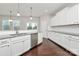 Well-lit kitchen featuring white cabinetry, a stainless steel dishwasher, and hardwood floors at 14812 Baytown Ct, Huntersville, NC 28078