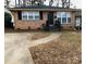 Brick ranch house with a landscaped yard and driveway at 1825 Herrin Ave, Charlotte, NC 28205