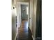 Hallway with hardwood floors and doors to bedrooms at 1825 Herrin Ave, Charlotte, NC 28205