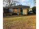 Rear view of brick house with deck and yard at 1825 Herrin Ave, Charlotte, NC 28205