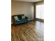 Living room with hardwood floors and teal couch at 1825 Herrin Ave, Charlotte, NC 28205