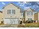 Two-story house with beige vinyl siding, a white garage door, and landscaping at 2010 Durand Rd, Fort Mill, SC 29715