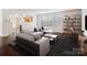 Living room with hardwood floors, staged furniture, and built-in shelving at 2010 Durand Rd, Fort Mill, SC 29715