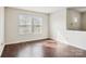 Living room featuring hardwood floors, neutral walls, and two large windows at 2010 Durand Rd, Fort Mill, SC 29715