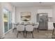 Dining area with glass table, light gray chairs, and sliding glass door at 2025 Tom Sadler Rd, Charlotte, NC 28214