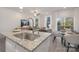 Kitchen island with stainless steel sink and view into the dining area at 2025 Tom Sadler Rd, Charlotte, NC 28214