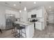 Kitchen with white cabinets, granite island, and stainless steel appliances at 2025 Tom Sadler Rd, Charlotte, NC 28214