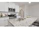 Granite countertop kitchen island with stainless steel sink and faucet at 2025 Tom Sadler Rd, Charlotte, NC 28214