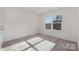 Bright bedroom with grey carpet and large window at 2029 Tom Sadler Rd, Charlotte, NC 28214