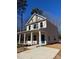 Two-story house with light beige siding, a blue door, and a paved driveway at 203 Benfield Rd, Kings Mountain, NC 28086