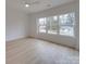 Light-filled bedroom with hardwood floors and large windows at 2039 Renner St, Charlotte, NC 28216