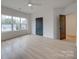 Hardwood floor bedroom with large window and a door at 2039 Renner St, Charlotte, NC 28216