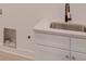 Laundry room with white cabinets and a modern sink at 2039 Renner St, Charlotte, NC 28216