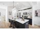 Modern kitchen with white and dark cabinets, quartz countertops, and an island with seating at 2041 Greenoak Dr, Shelby, NC 28152