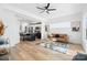 Open concept living room and kitchen with hardwood floors, and a brown leather sofa at 2041 Greenoak Dr, Shelby, NC 28152