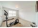 Well-lit bedroom with an elliptical machine, perfect for a home gym at 2131 Ashley Glen Way, Indian Land, SC 29707